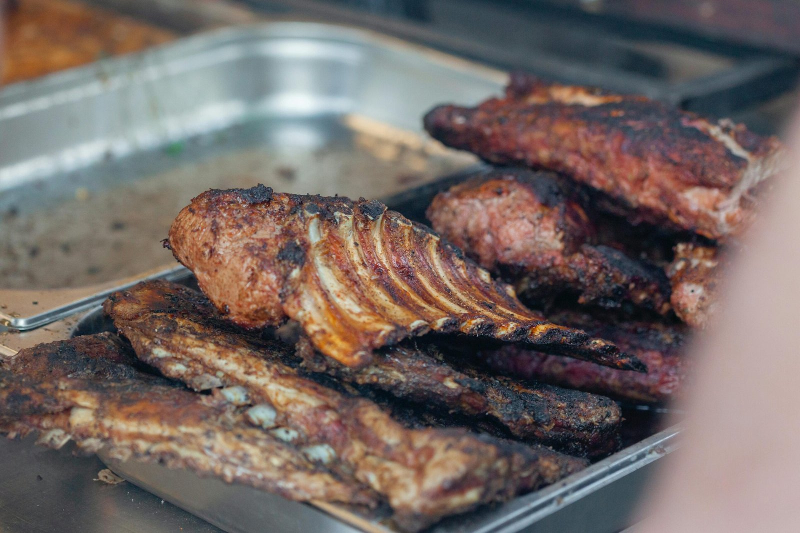 Close-up of delicious grilled ribs fresh from the BBQ grill, perfect for a summer feast.